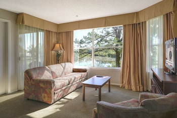 Deluxe Condo, 2 Bedrooms | Living area | 32-inch flat-screen TV with cable channels, TV at Parc Corniche Condominium Suite Hotel