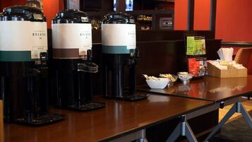 A coffee station with three coffee dispensers labeled "Breathe Bold" and "Breathe Decaf" in a hotel setting.