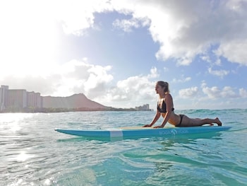 A beachside event with palm trees and a crowd. at OUTRIGGER Waikiki Beach Resort