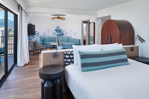 A modern hotel room with a large bed, a sofa, a dining table, and a view of the outdoors. - OUTRIGGER Waikiki Beach Resort (Honolulu)