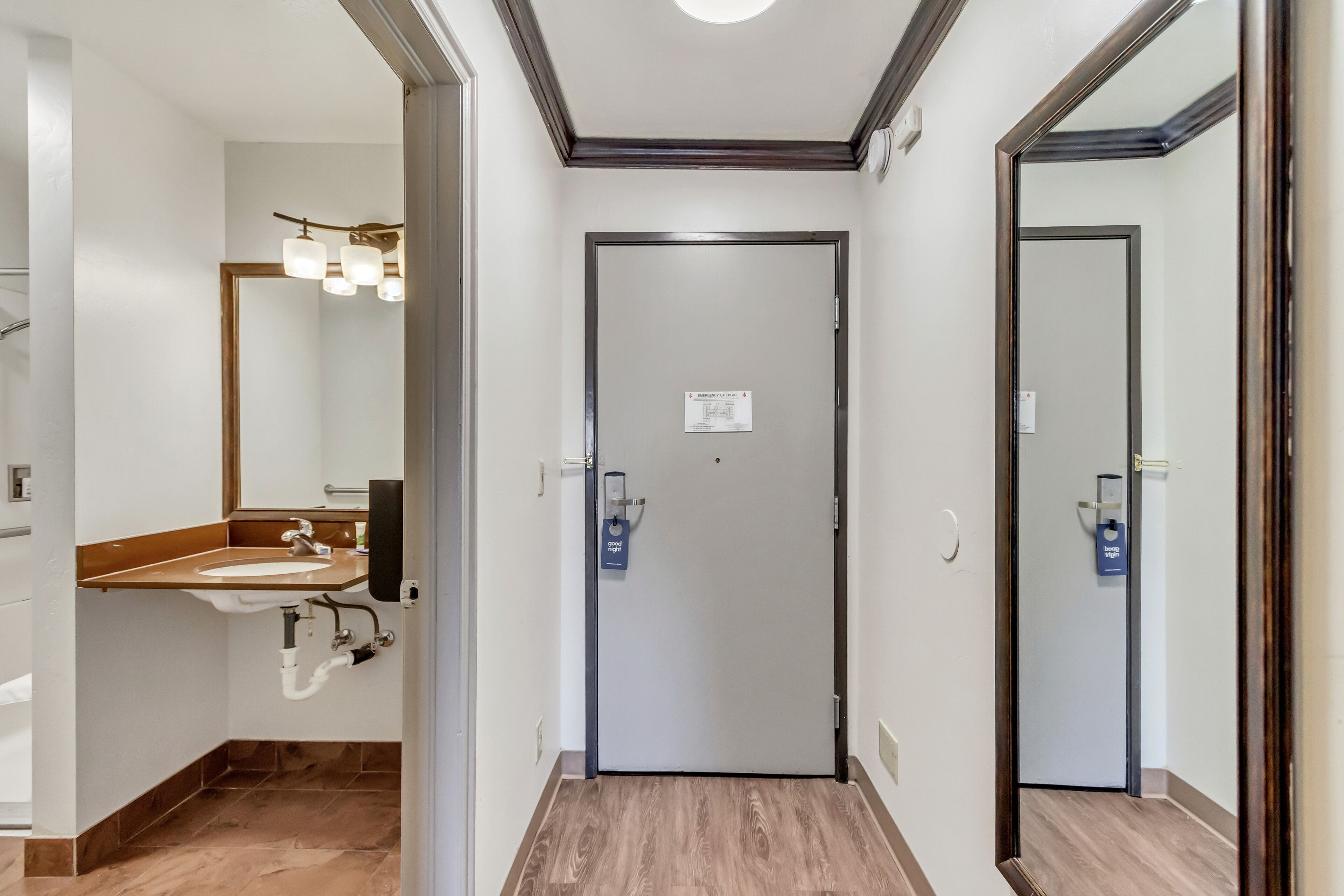 A modern bathroom with a sink, mirror, and vanity.