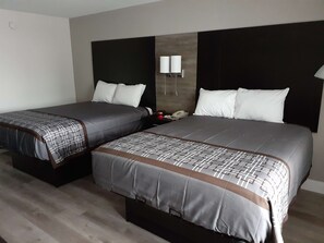 Habitación estándar, 2 camas de matrimonio | Tabla de planchar con plancha, wifi gratis, ropa de cama