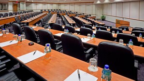A conference room with long tables, black chairs, water bottles, and nameplates. - Crowne Plaza: Philadelphia - King of Prussia by IHG (King of Prussia)
