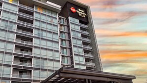 A modern hotel building with a prominent sign reading "Best Western Plus."