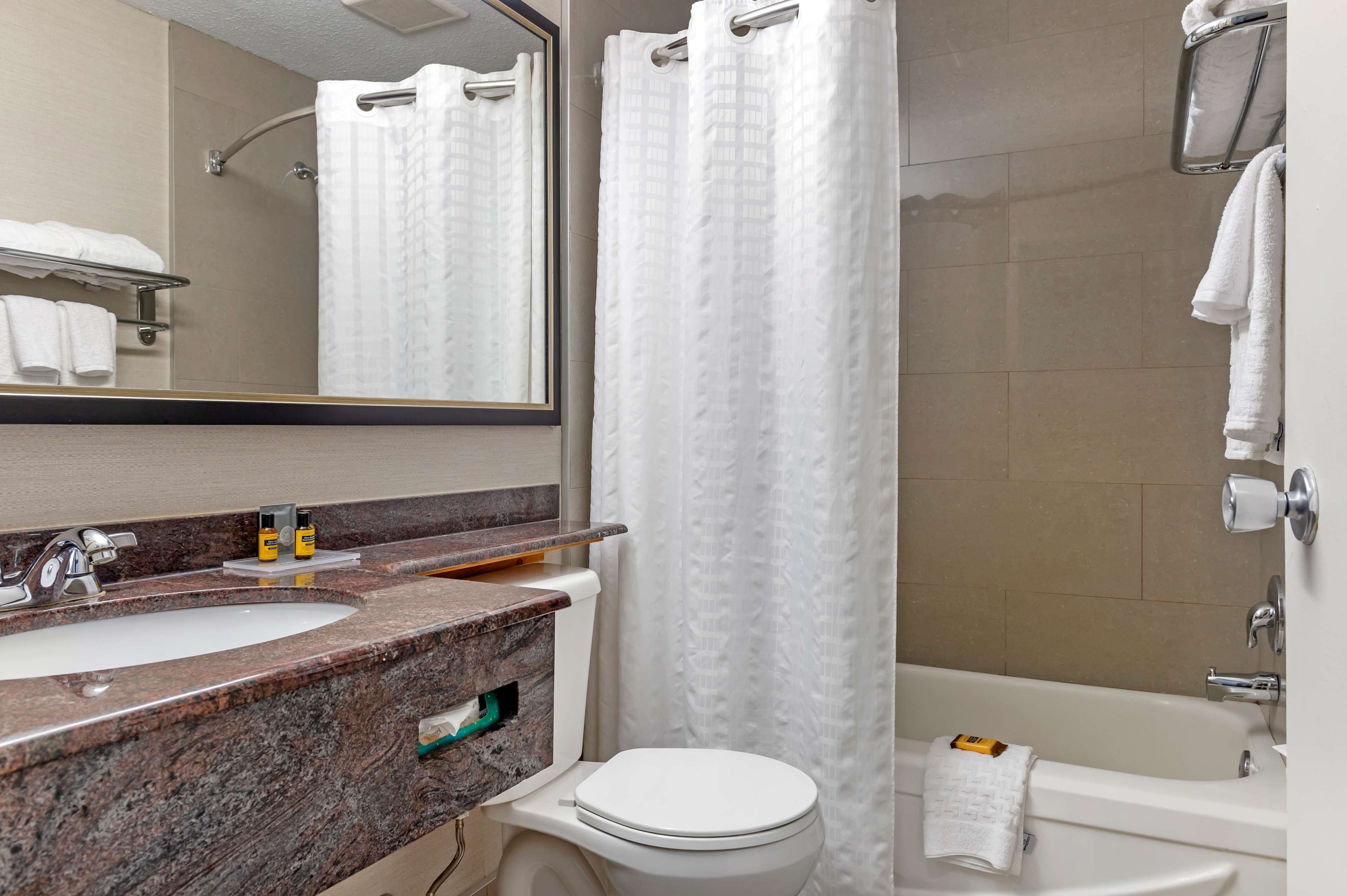 A bathroom with a sink, toilet, and bathtub.