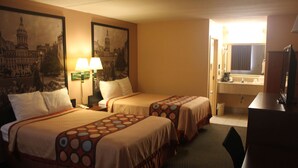 A hotel room with two beds, a desk, a chair, a lamp, a mirror, and a painting of a building. - Super 8 by Wyndham Laurel (Laurel)