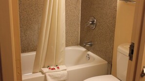 A bathroom with a bathtub, a toilet, and a shower curtain. - Super 8 by Wyndham Laurel (Laurel)