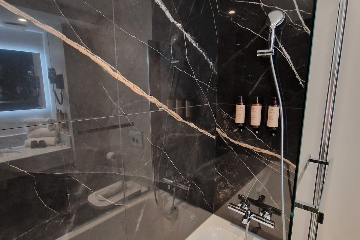 deluxe room, 1 double bed with sofa bed | bathroom | eco-friendly toiletries, hair dryer, towels