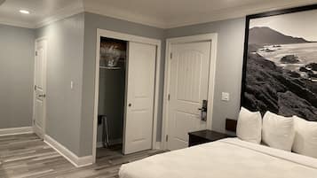 A bedroom with a bed, a closet, and a door leading to a bathroom.