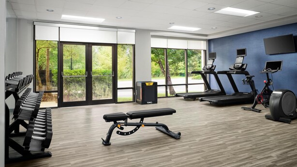A gym with treadmills, stationary bikes, and weight machines.