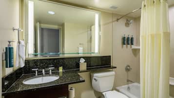 A bathroom with a sink, toilet, and bathtub.
