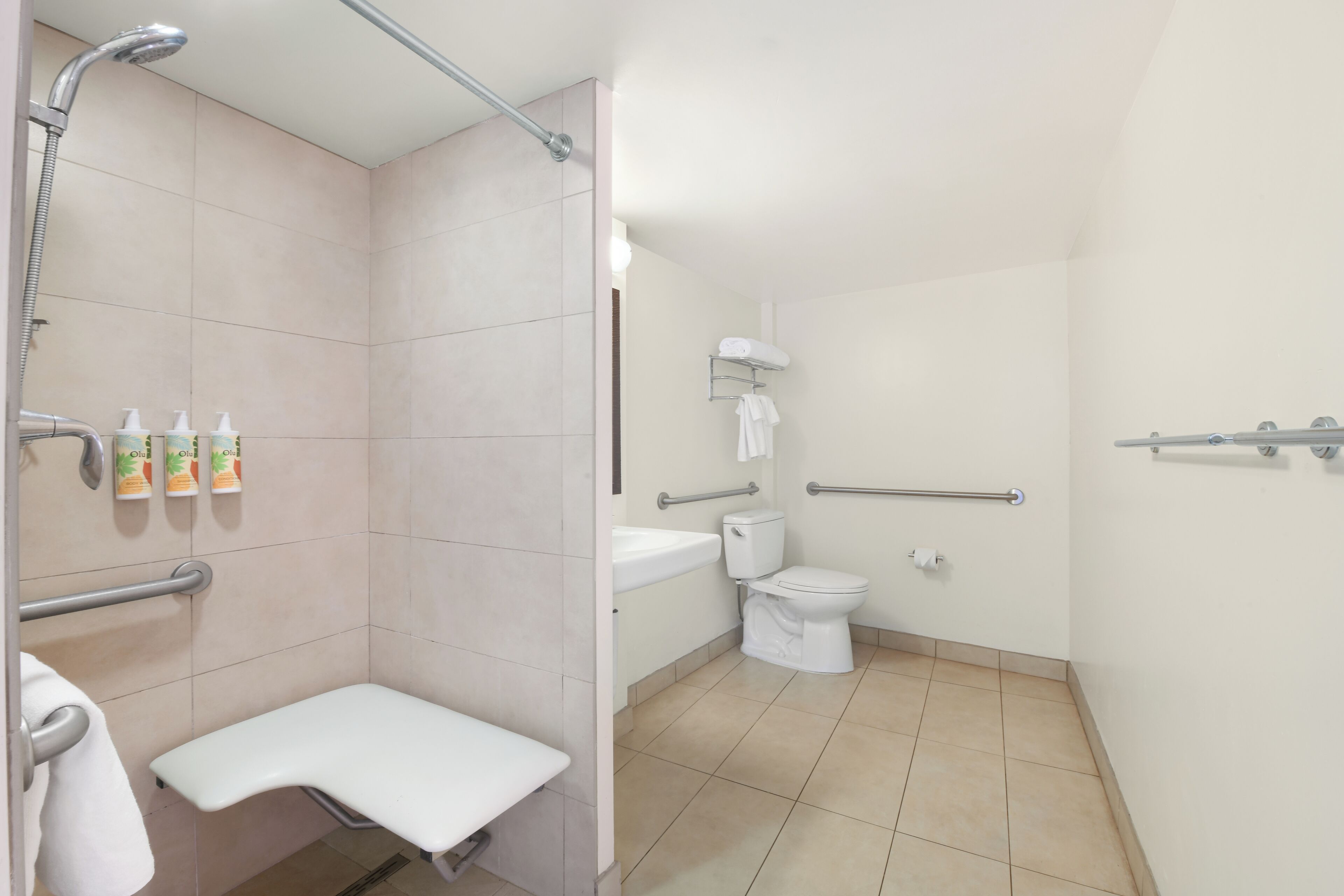 junior suite, ocean view (diamond head - ada) | bathroom | eco-friendly toiletries, hair dryer, towels