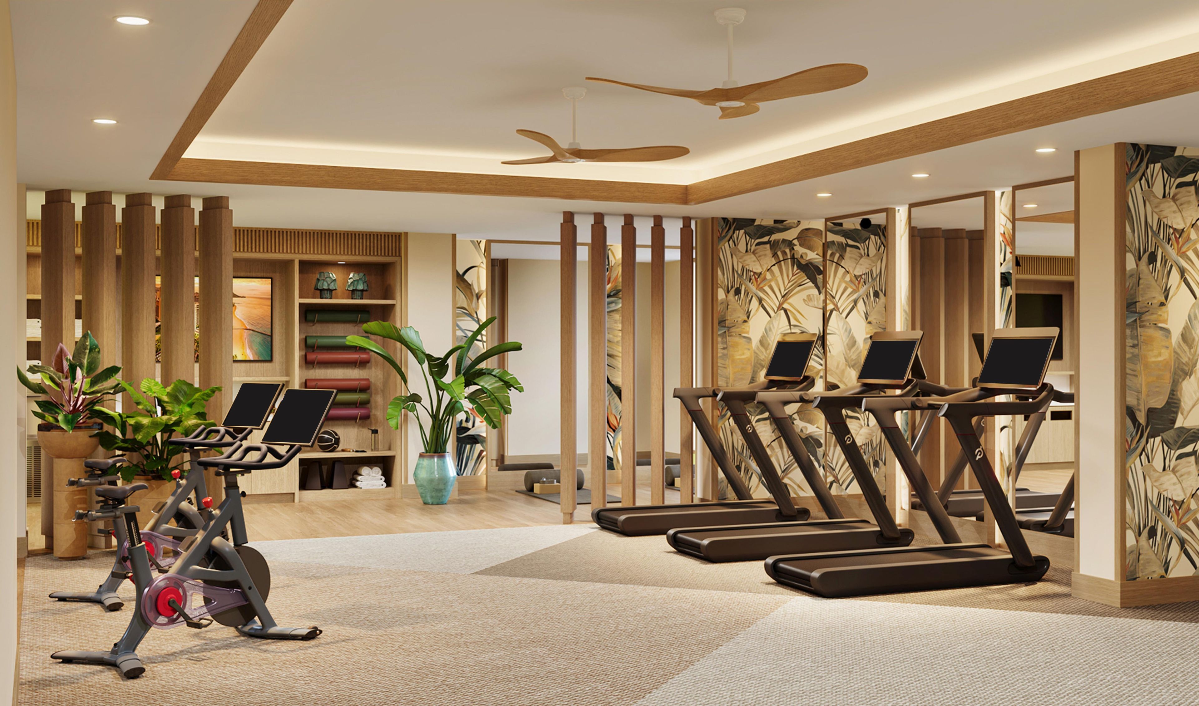 A gym with exercise equipment, a ceiling fan, and a wall with a leaf pattern.