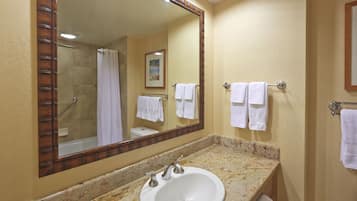 A bathroom with a sink, mirror, and towel rack.