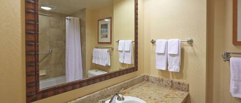 A bathroom with a sink, mirror, and towel rack.