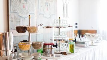 A buffet setup with various food containers and serving utensils.