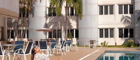 Outdoor pool, open 9:00 AM to 10:00 PM, pool umbrellas, sun loungers