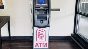 An ATM machine in a Red Roof Inn, with a sign indicating its location. - Red Roof Inn Chapel Hill - UNC (Durham)