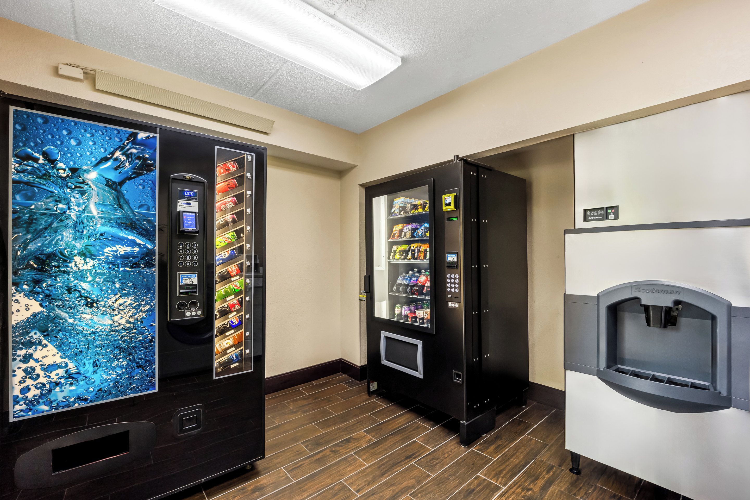 A vending machine area with a water dispenser and a digital display.