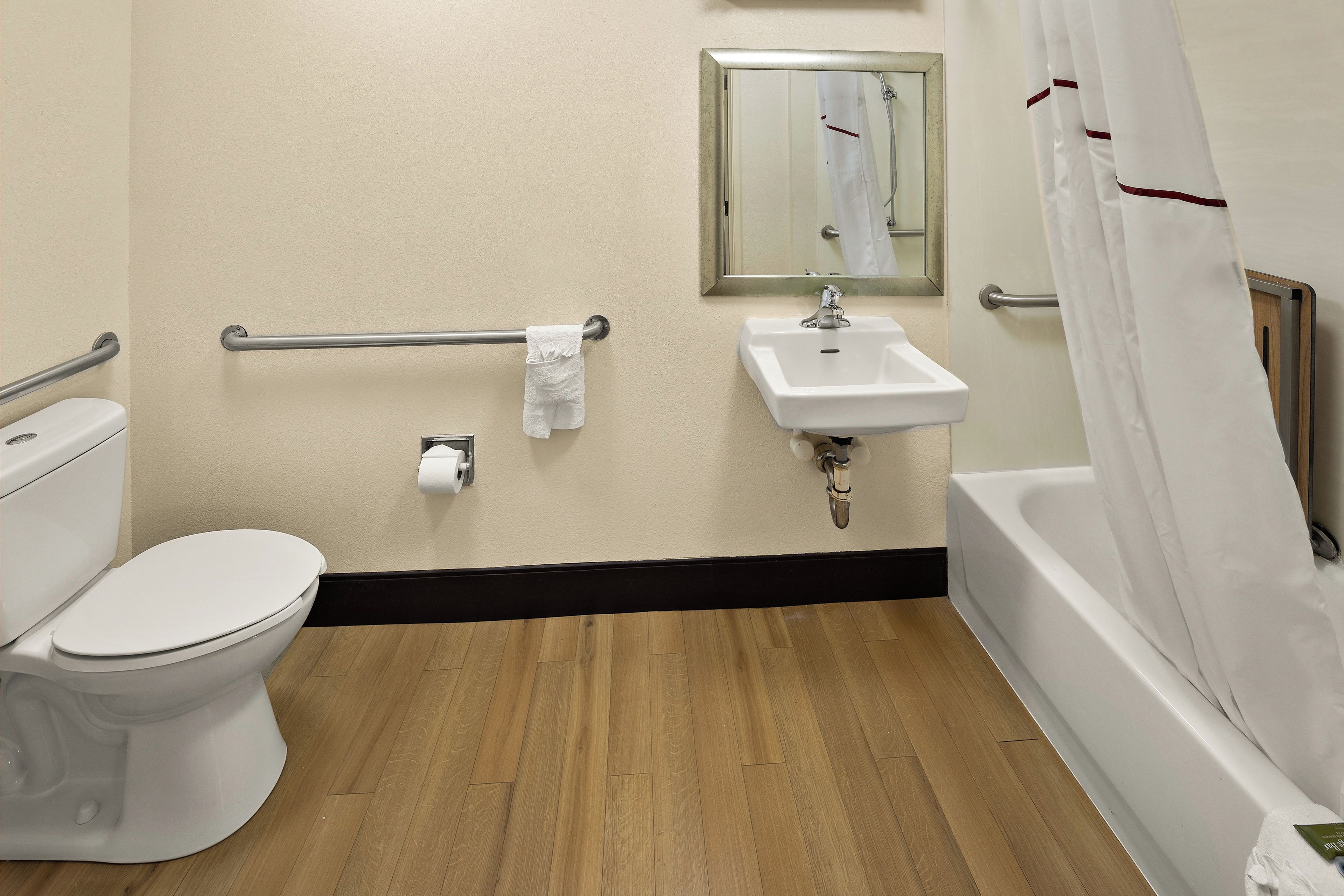 A standard hotel bathroom with a toilet, sink, and bathtub.