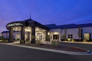 A hotel entrance with a covered area, columns, and a sign reading 'DOUBLETREE by Hilton'. - DoubleTree by Hilton Detroit Novi (Novi)