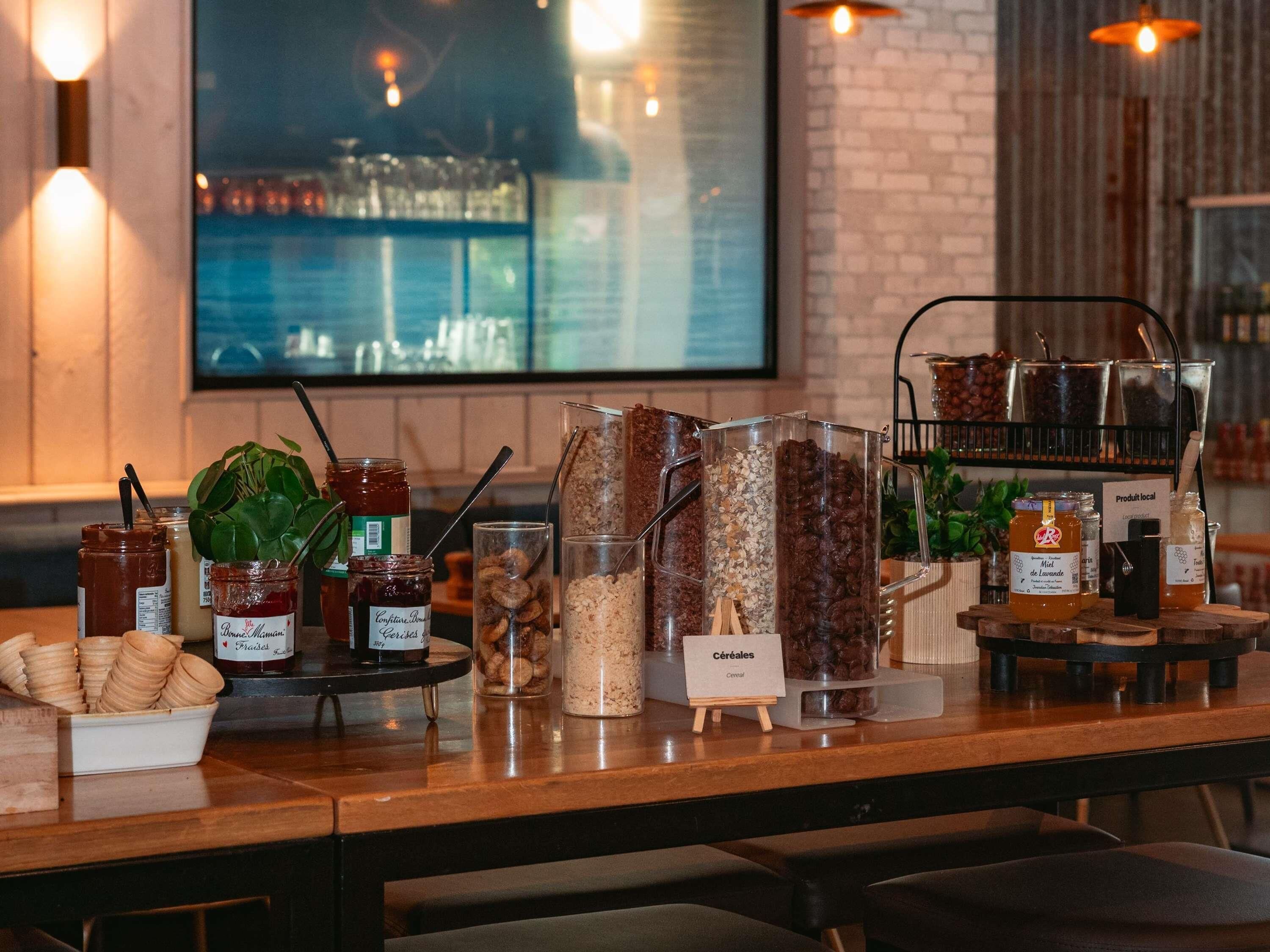 A breakfast buffet with various food items and condiments.