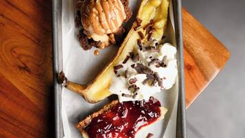 A dessert tray with various sweets on parchment paper.