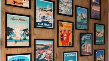 A collection of framed travel posters on a wooden wall.