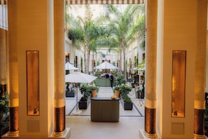 A courtyard with a central seating area, surrounded by columns and potted plants. - Hôtel de Paris Monte-Carlo (Monaco)