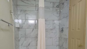 A bathroom with a bathtub, a shower, and a toilet. - Americas Best Value Inn Williams Grand Canyon (Williams)