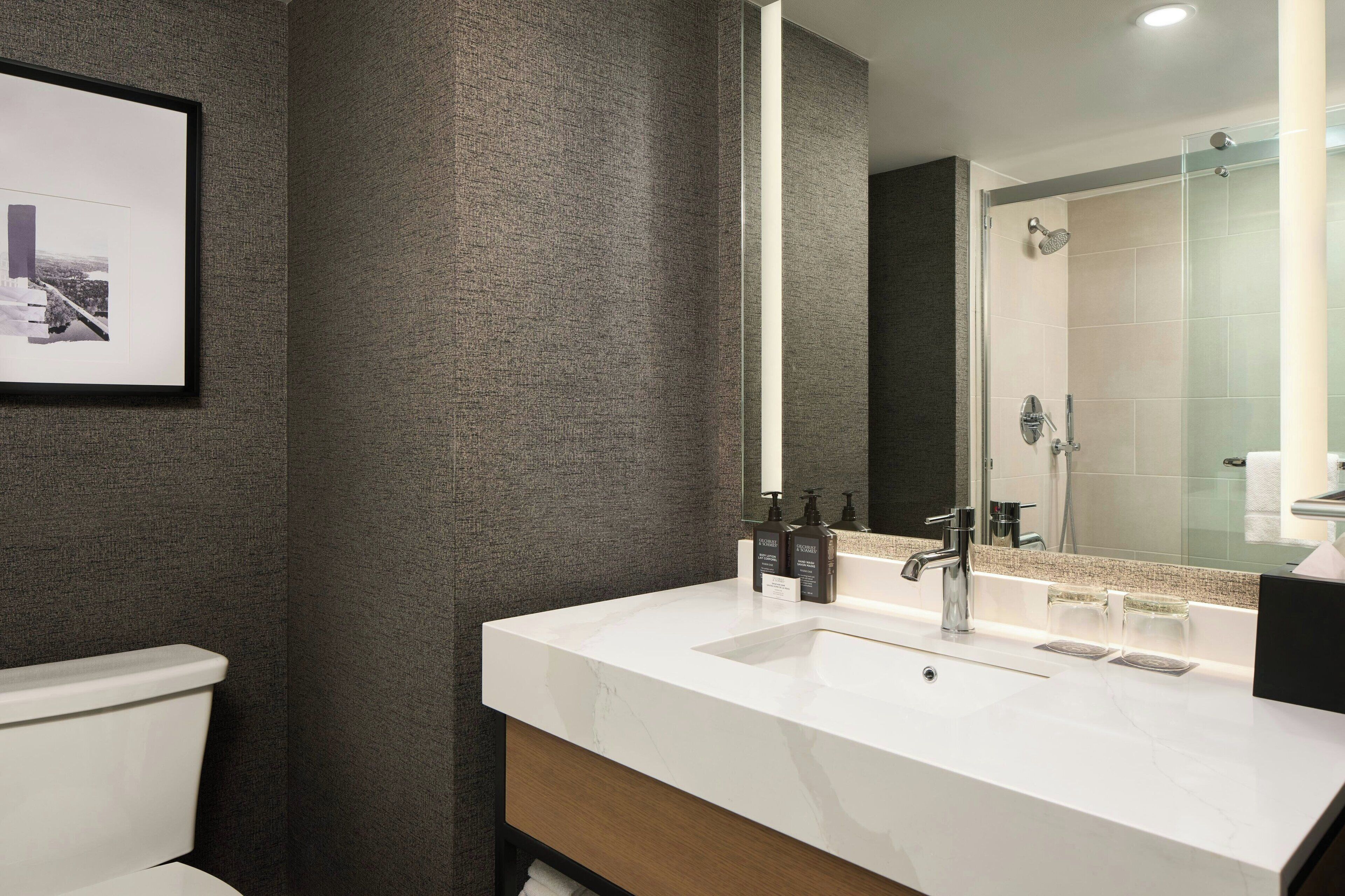 combined shower/bathtub, designer toiletries, hair dryer, towels