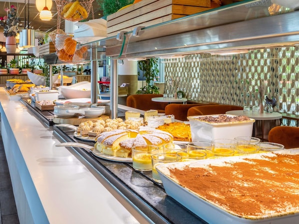 A buffet with various desserts and beverages.