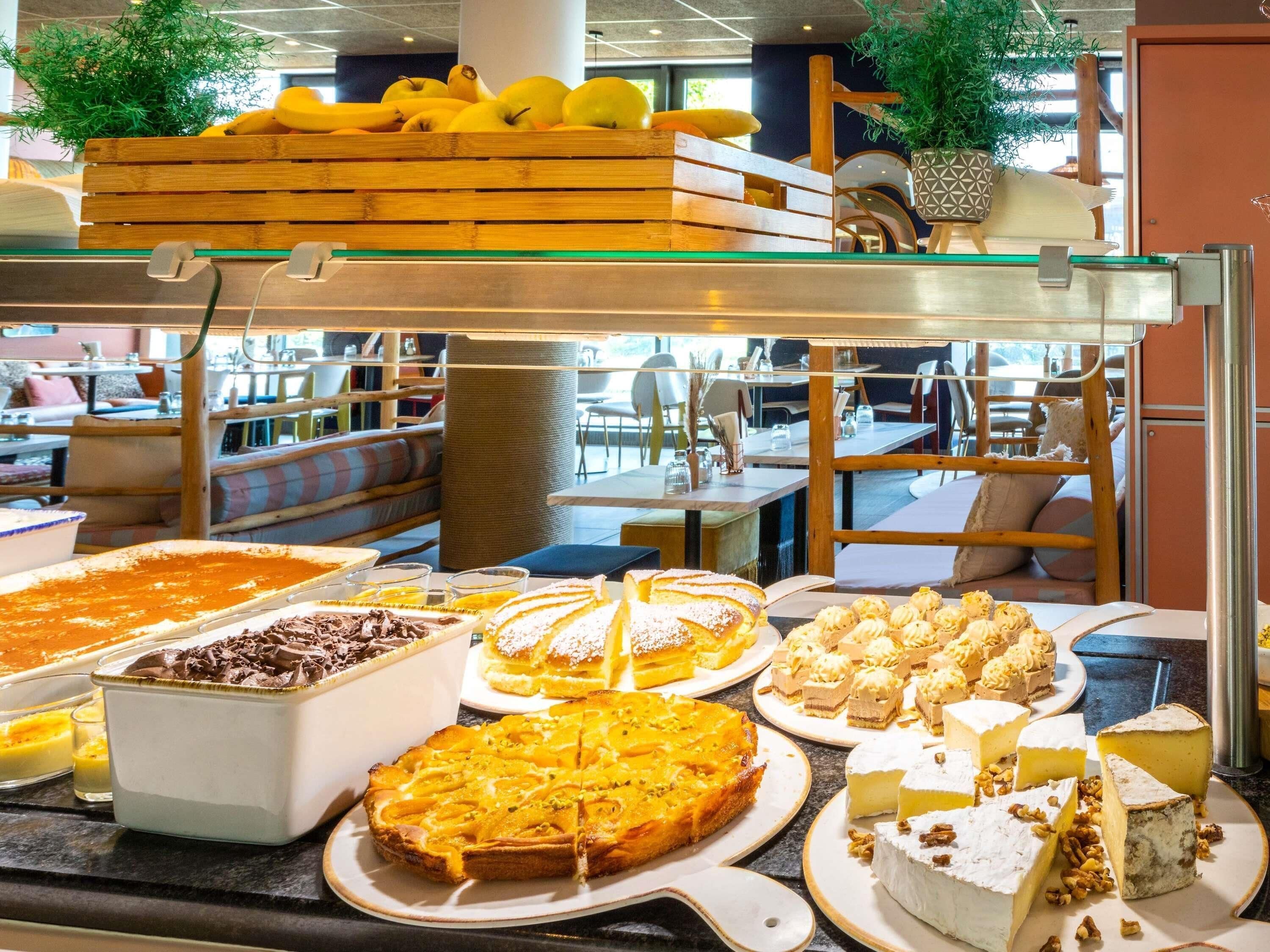 A buffet with various desserts and fruits.