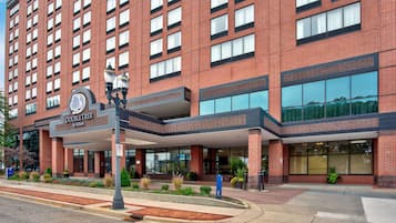 A DoubleTree by Hilton hotel with a brick facade, large windows, and a covered entrance area.