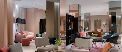 A modern living room with sofas, armchairs, and a coffee table.