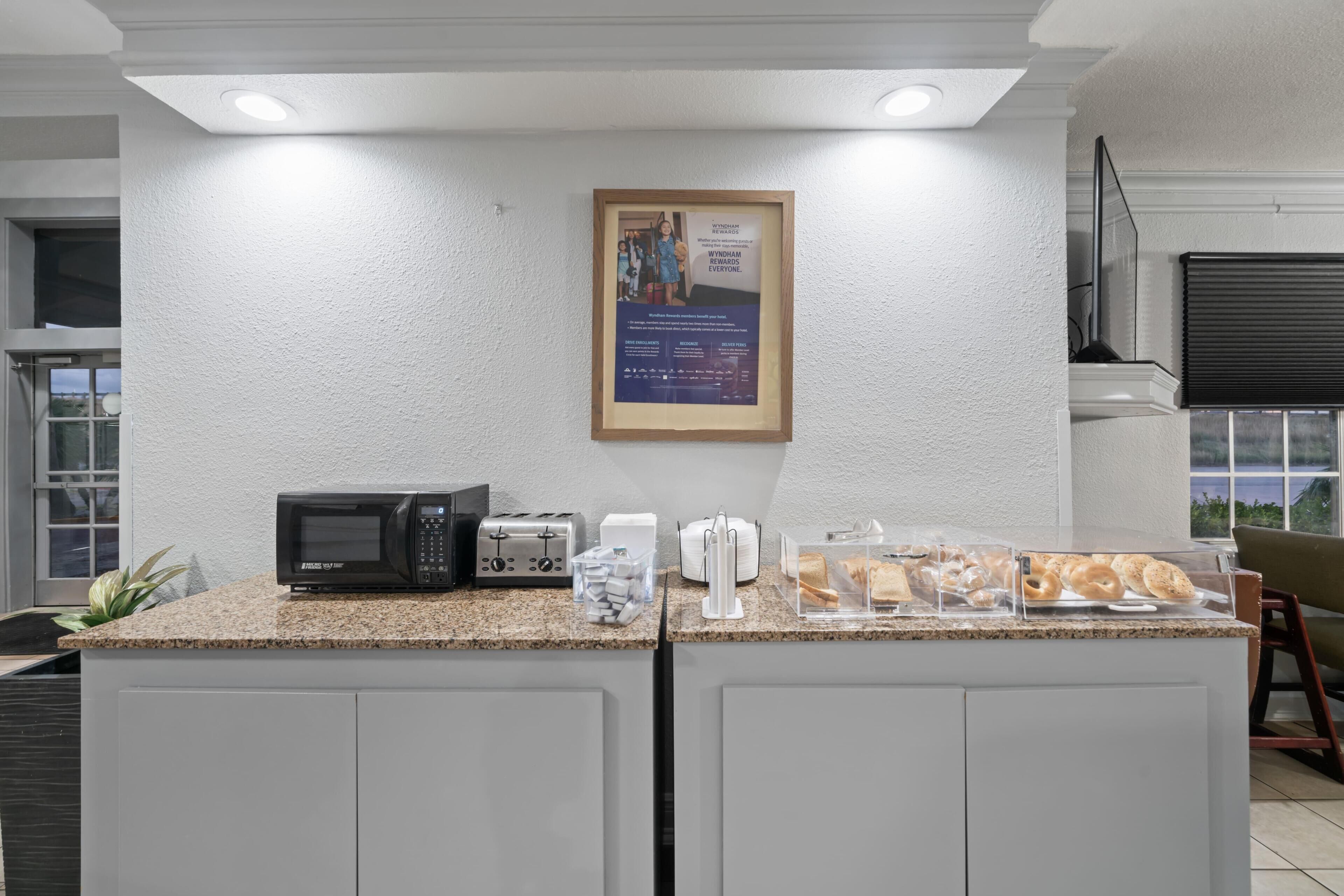 A kitchenette with a microwave, toaster, and bread display.