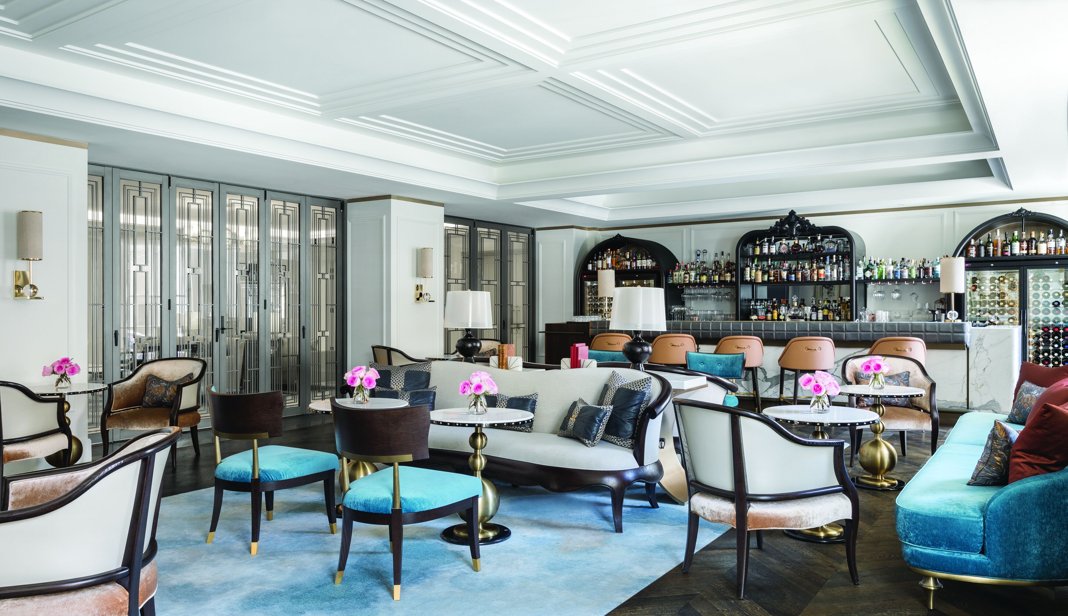 A bar area with a variety of seating options and a well-stocked liquor display.