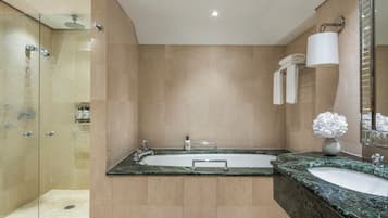 A modern bathroom with a glass-enclosed shower, a double sink vanity, and a large mirror.