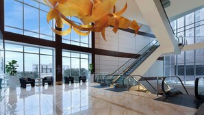 A spacious lobby with a large glass window, an escalator, and seating areas. - Renaissance Dallas Hotel (Dallas)