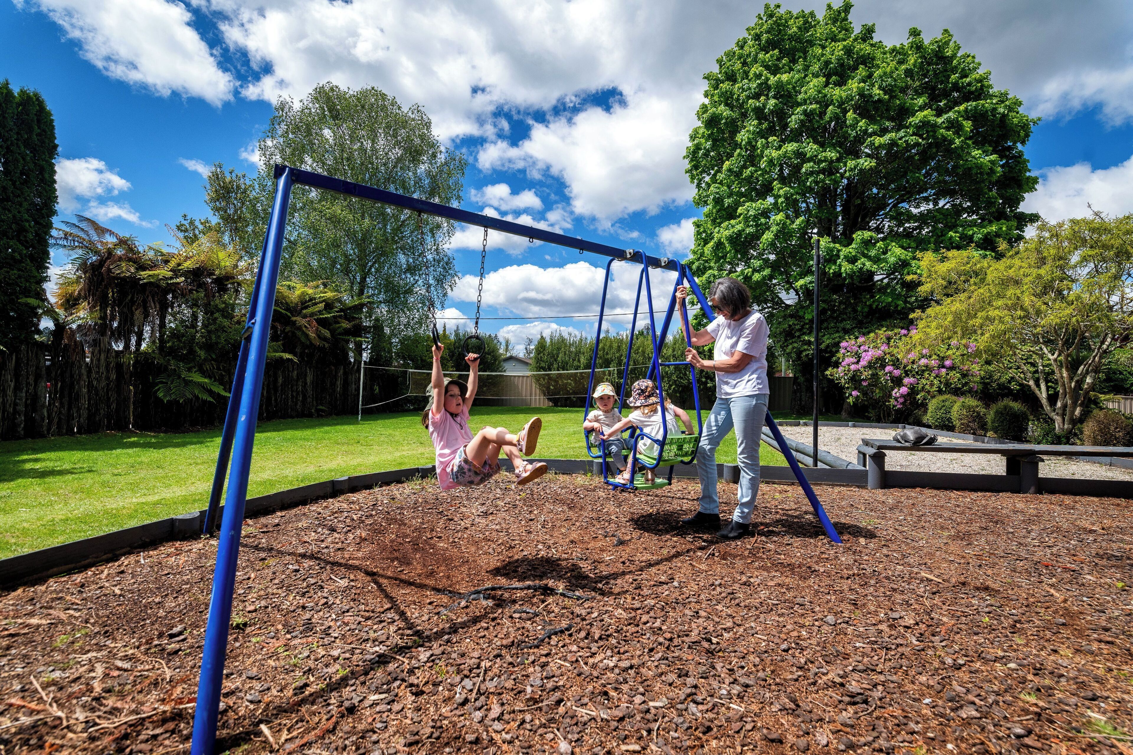 A playground with swings and a metal frame.