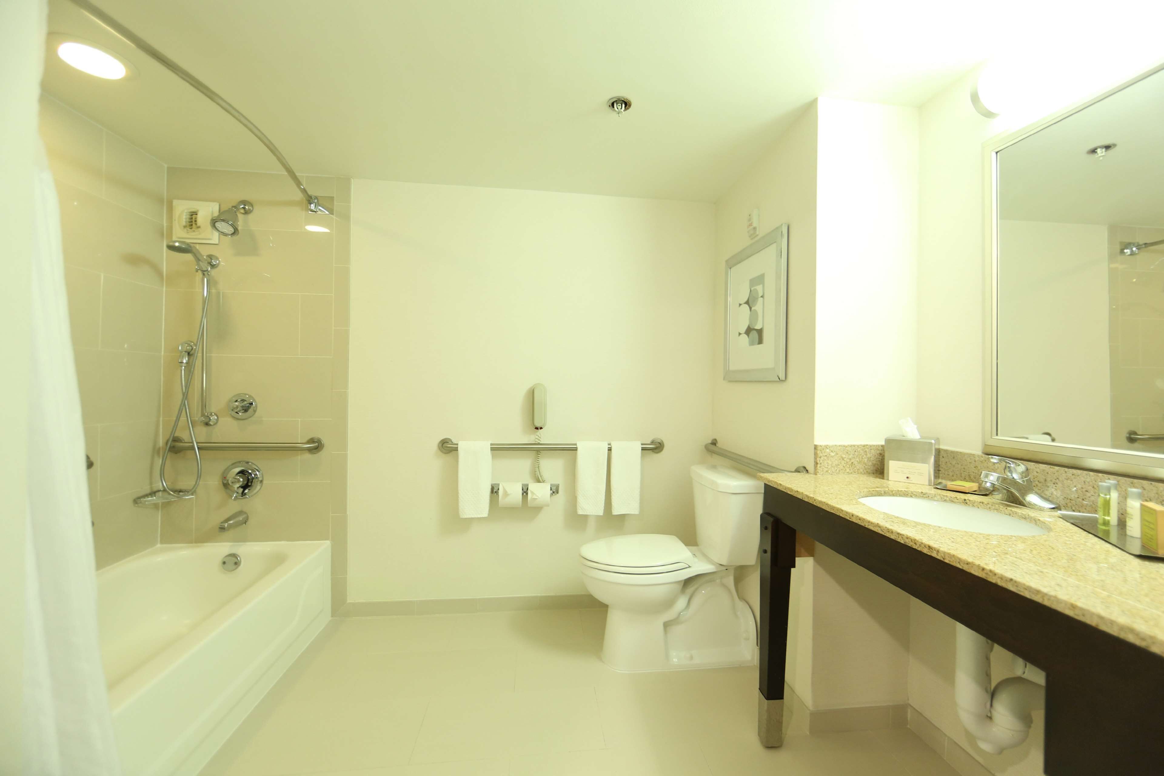 A bathroom with a bathtub, toilet, and sink.