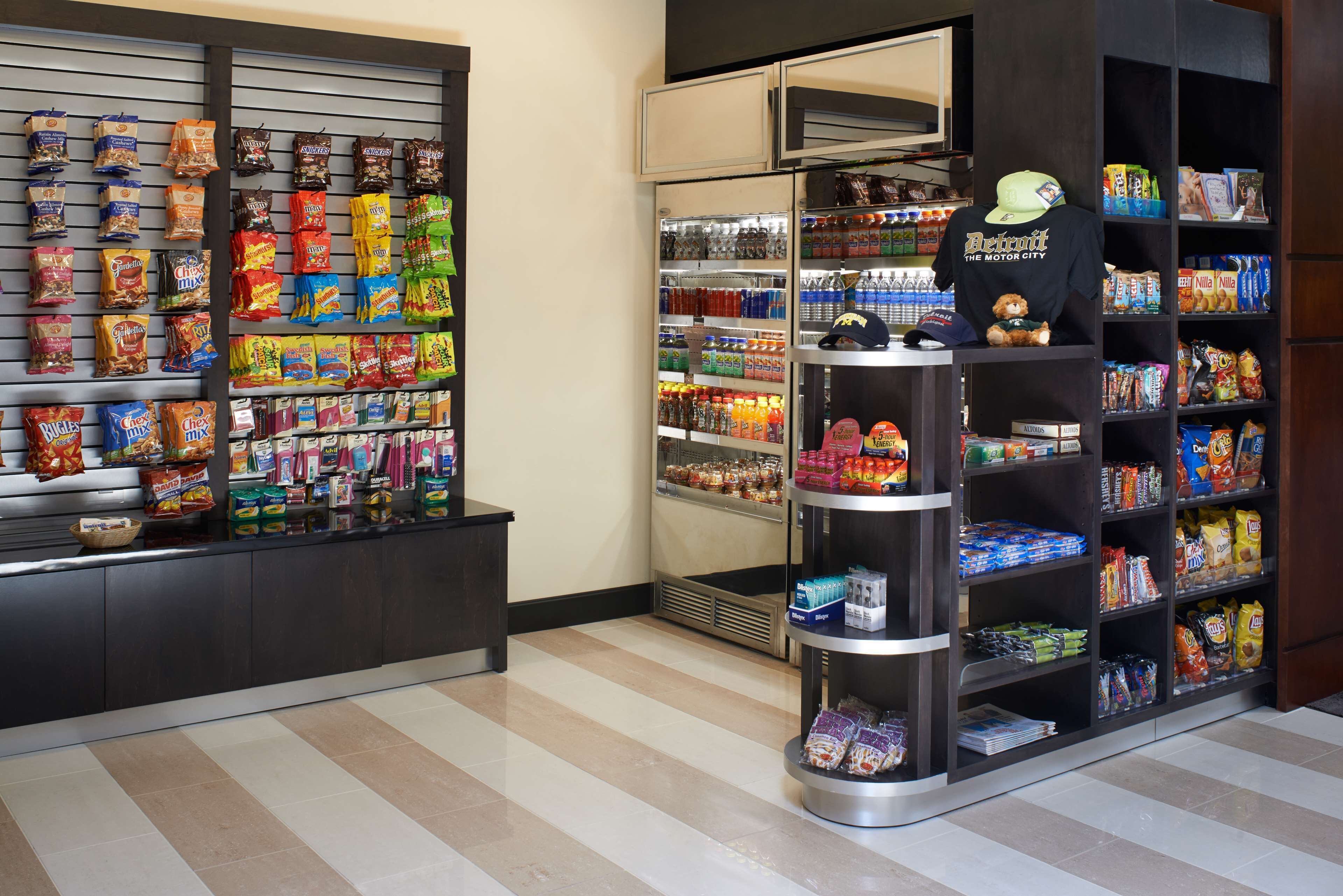 A snack display with various packaged foods and a refrigerated section with beverages.