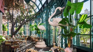 An indoor dining area with tables, chairs, and decorative elements like swans and hanging ornaments. - Flamingo Las Vegas Hotel & Casino (Las Vegas)