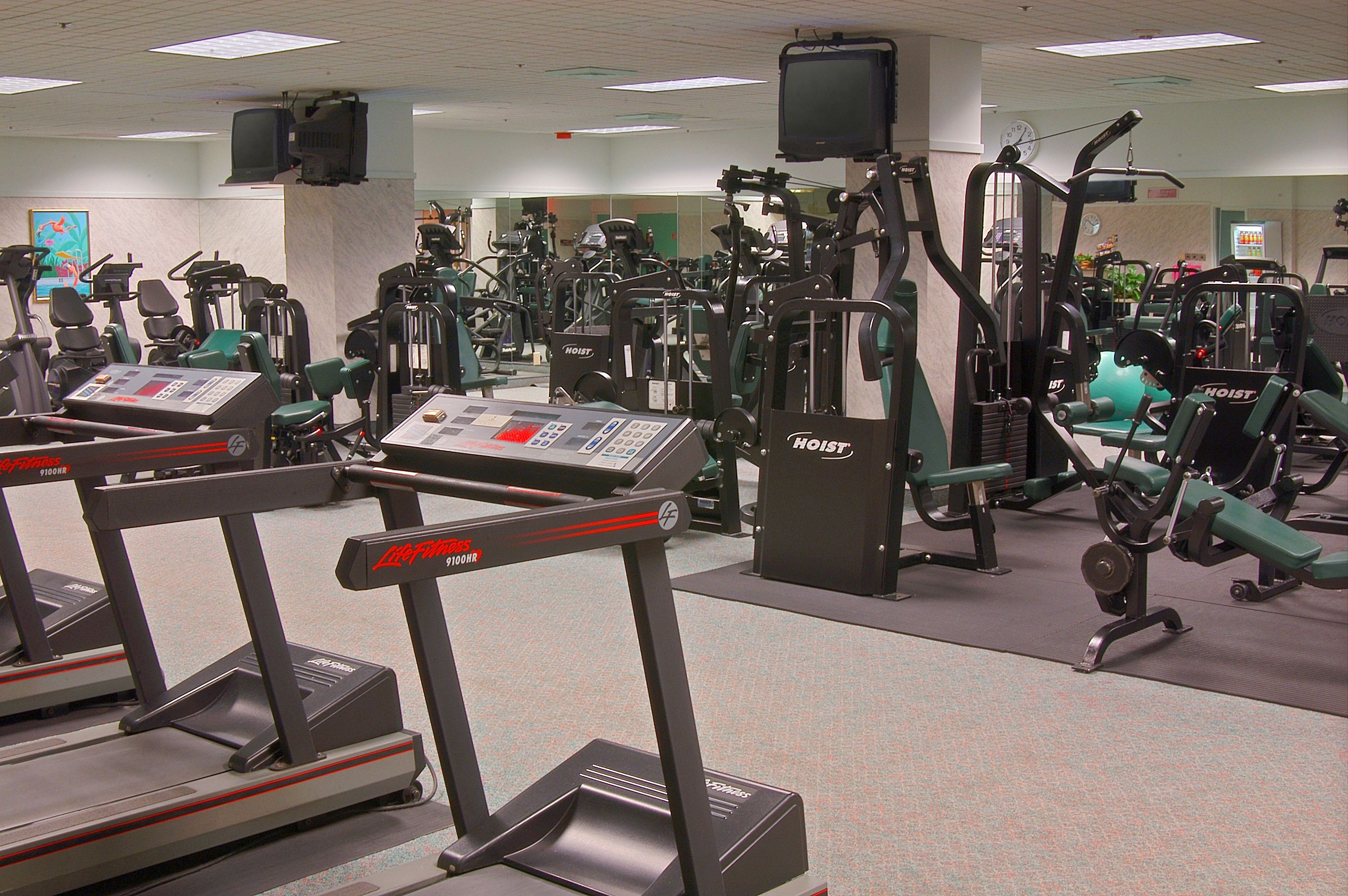 A gym with treadmills, stationary bikes, and various exercise machines.