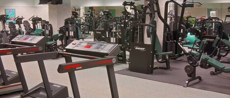 A gym with treadmills, stationary bikes, and various exercise machines.