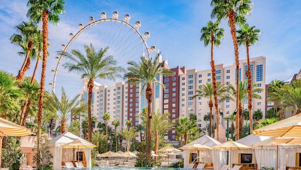 A hotel pool with a Ferris wheel, palm trees, and modern buildings in the background. - Flamingo Las Vegas Hotel & Casino (Las Vegas)