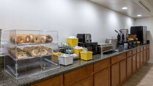 A breakfast bar with a variety of pastries and a coffee station. - Days Inn by Wyndham Casper (Casper)