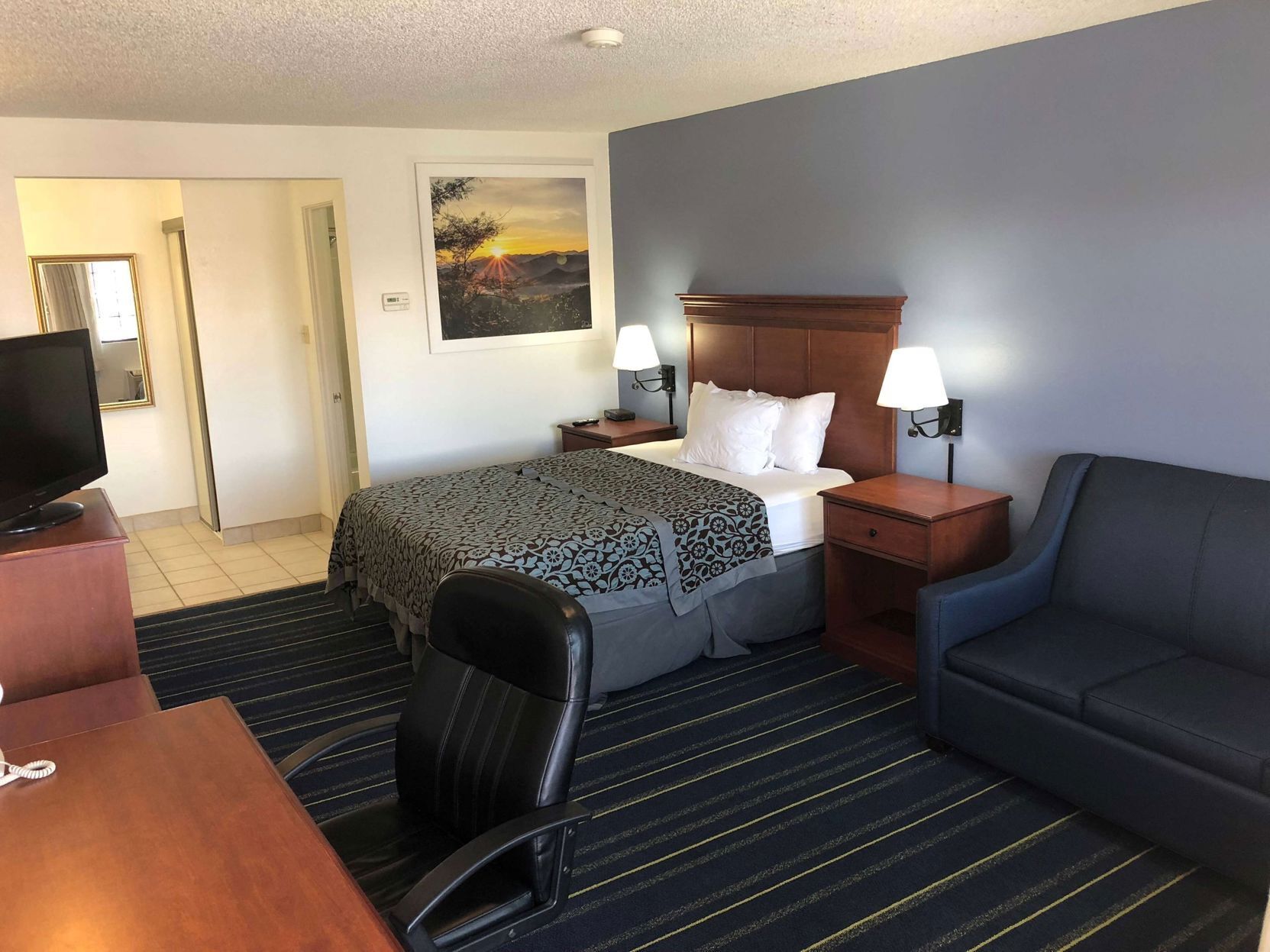 Premium bedding, desk, laptop workspace, blackout curtains