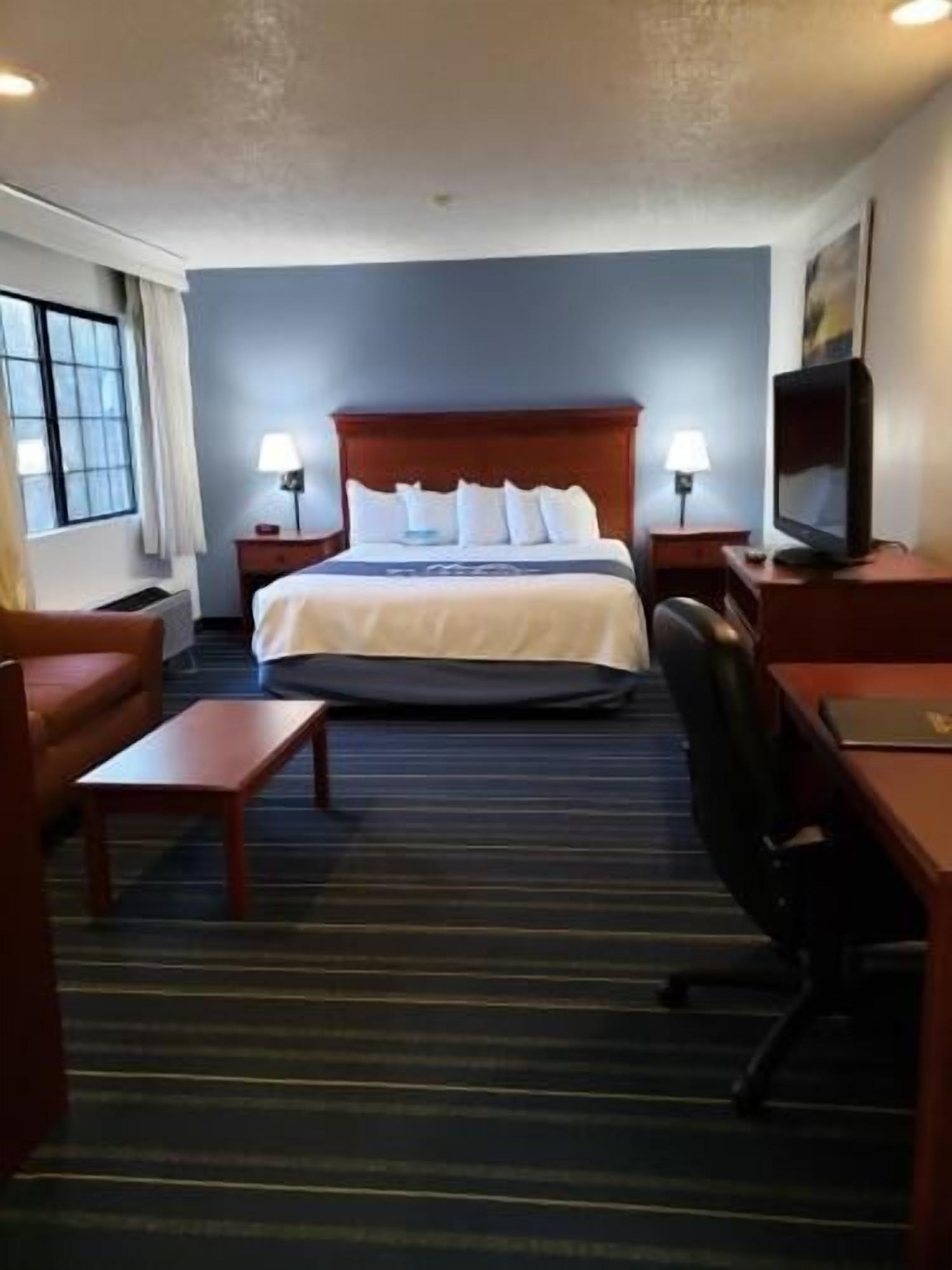 Premium bedding, desk, laptop workspace, blackout curtains