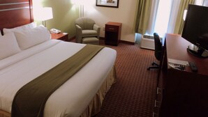 A hotel room with a large bed, a desk with a television, a chair, a nightstand, and a picture on the wall. - Holiday Inn Express Harrisburg SW - Mechanicsburg by IHG (Mechanicsburg)